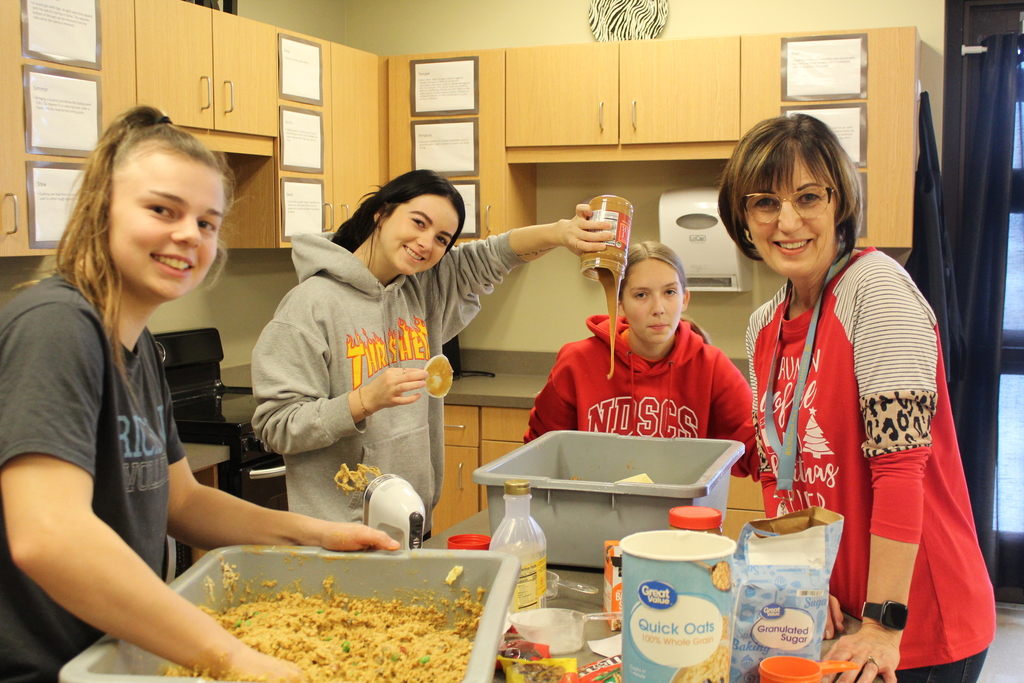 students and staff making cookies